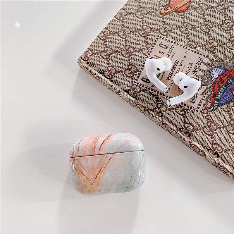 Marble-patterned protective Apple AirPods covers with precise fit and durable hard plastic design.